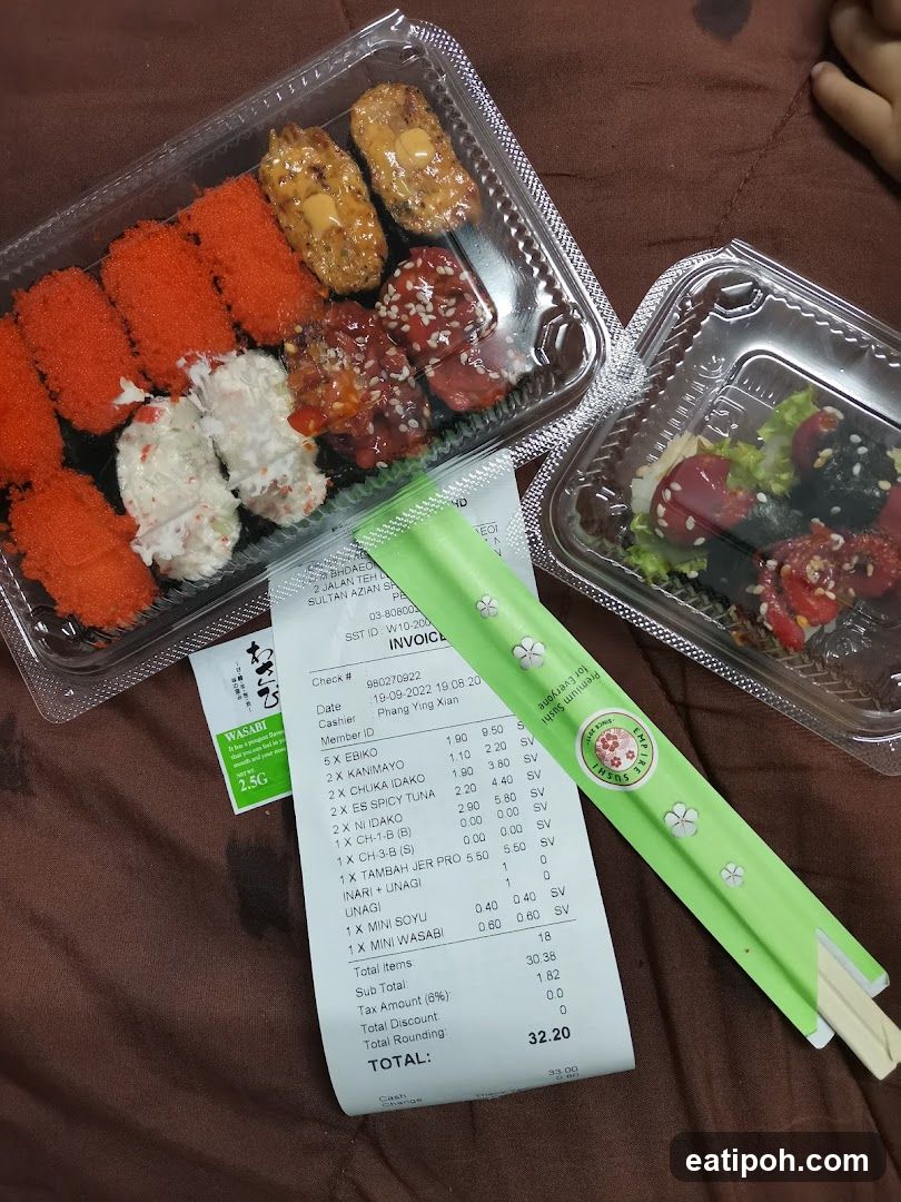 Sushi and salad containers with receipt and chopsticks