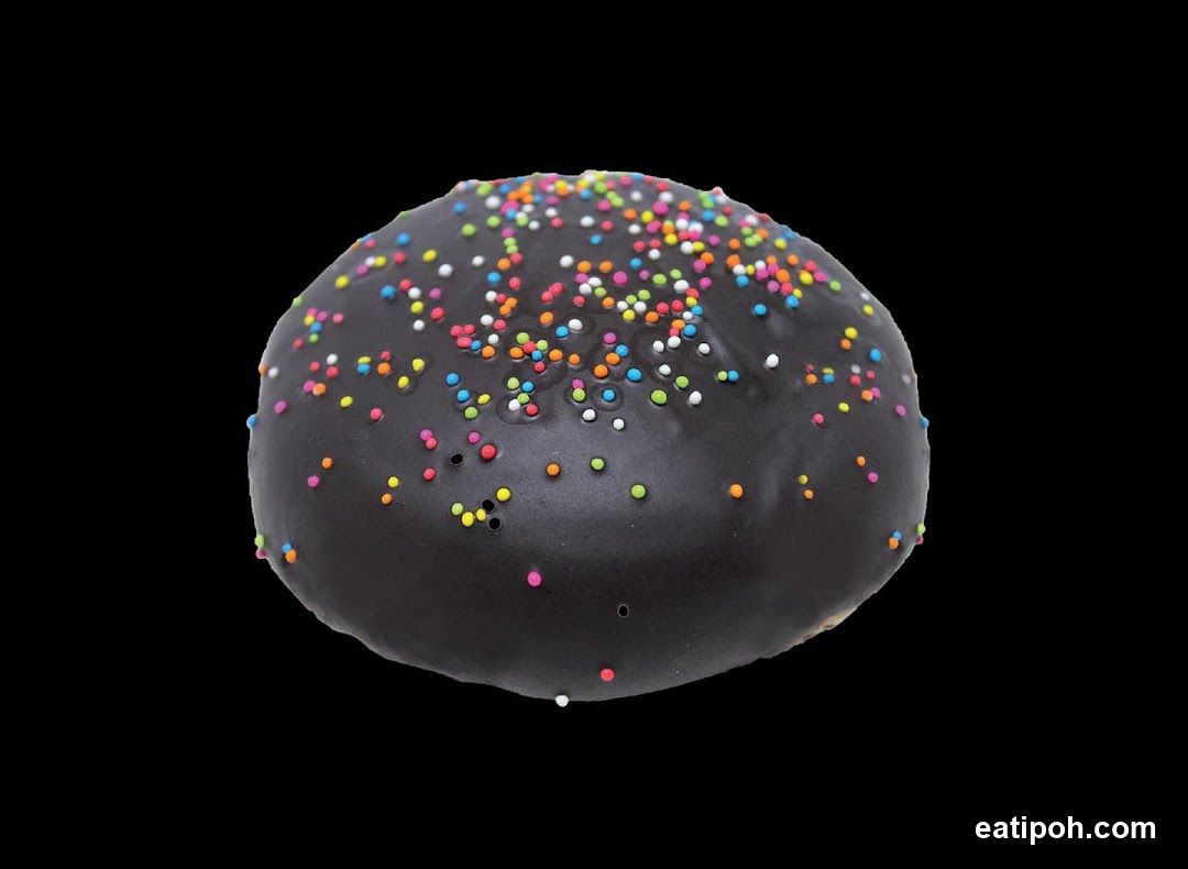 Chocolate-covered bun with sprinkles