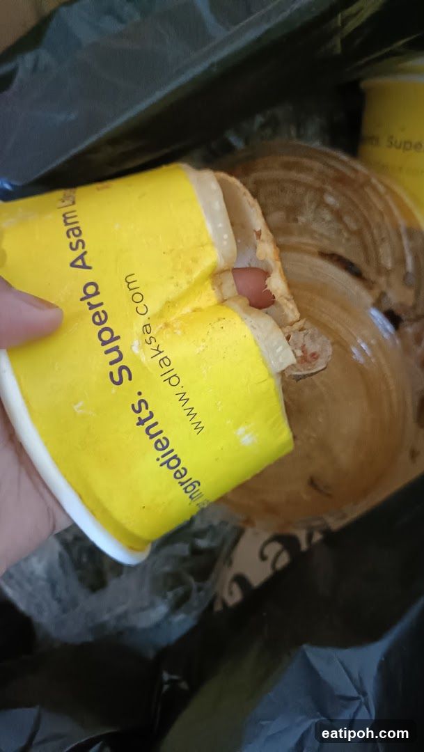 Hand holding a yellow cup from Superb Aseam
