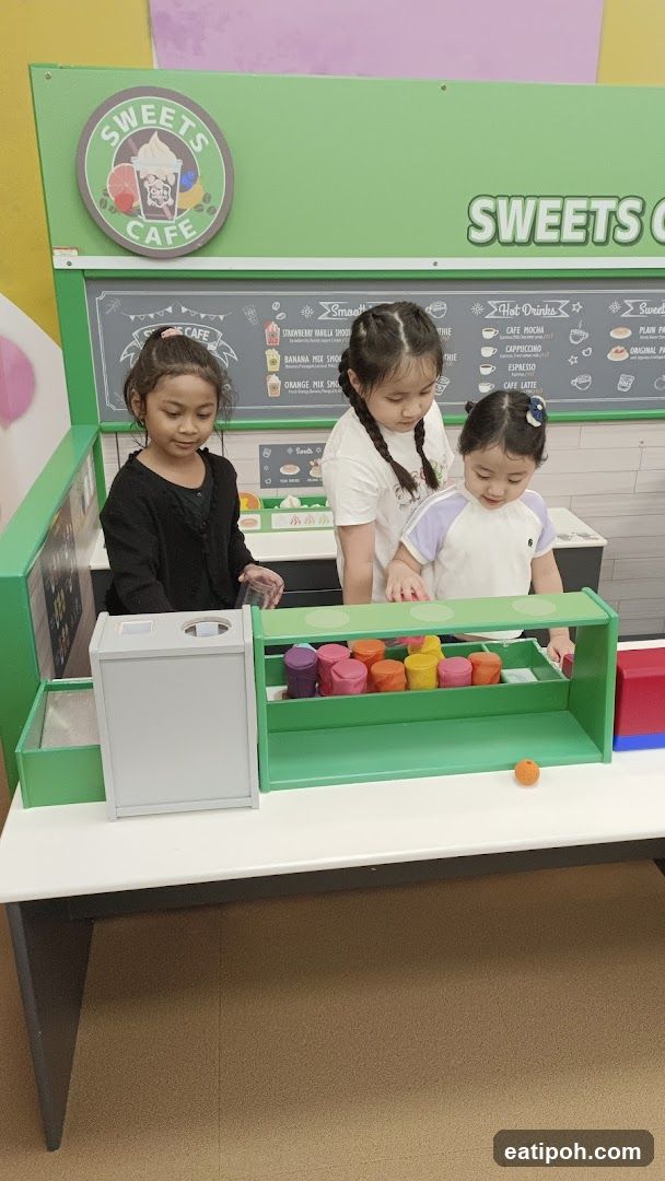 Children playing at a toy cafe station