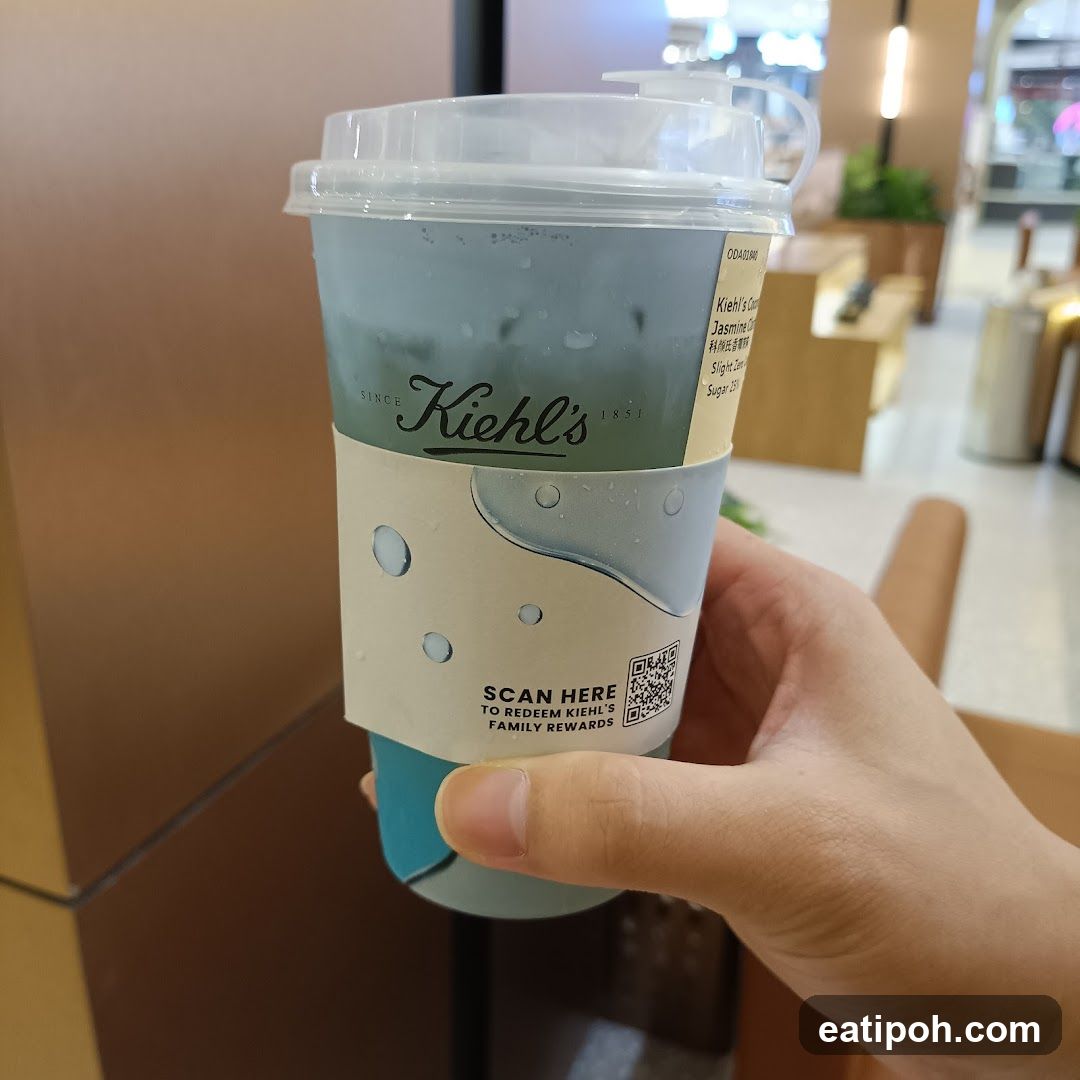 Hand holding Kiehl's branded drink cup