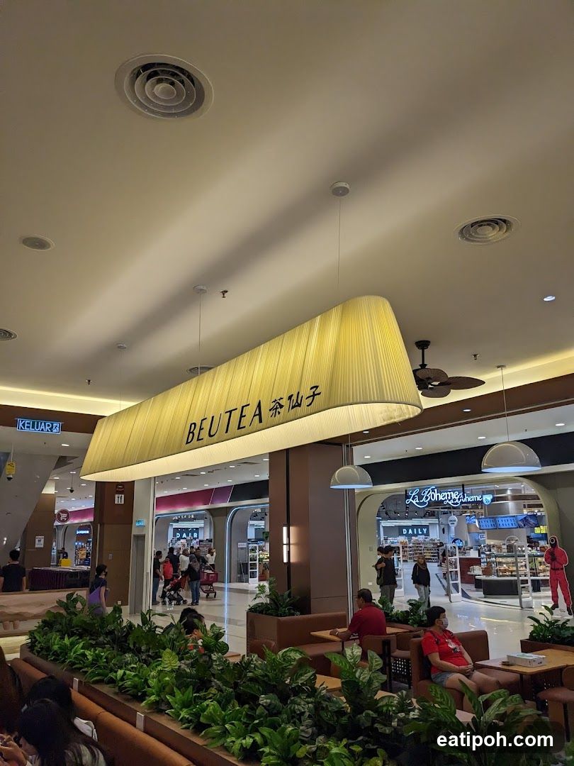 Interior of shopping mall with BEUTEA storefront