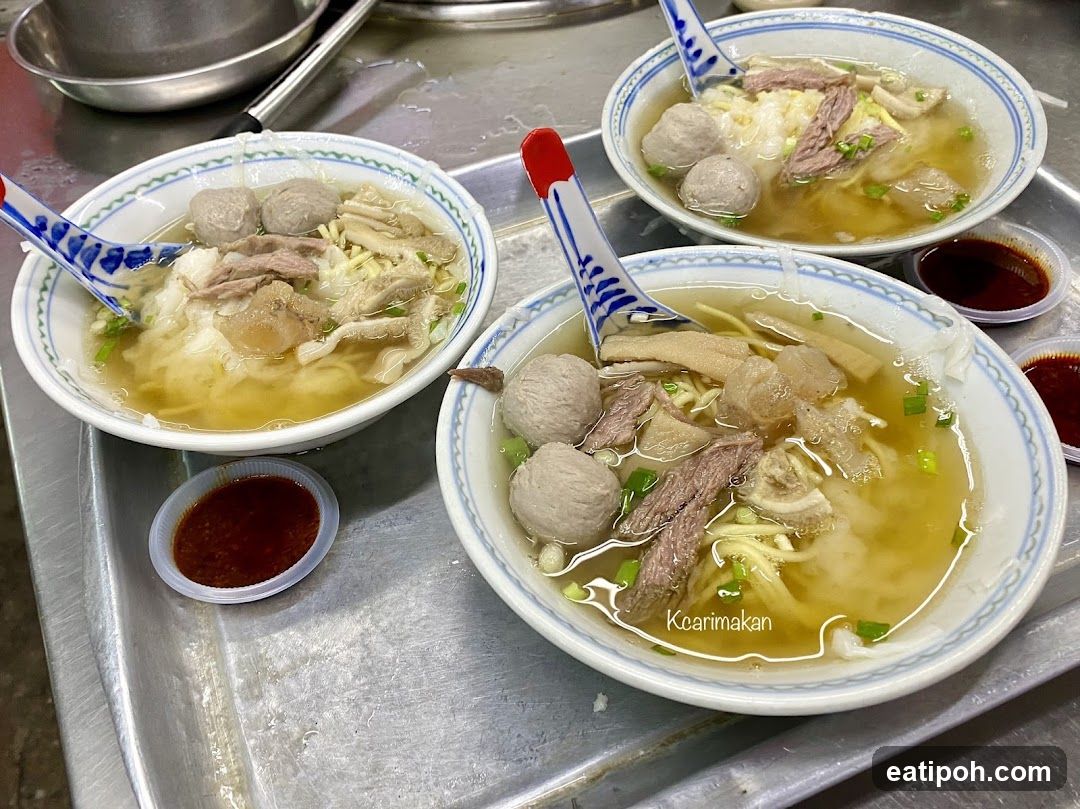 Bowl of noodle soup with meatballs and beef