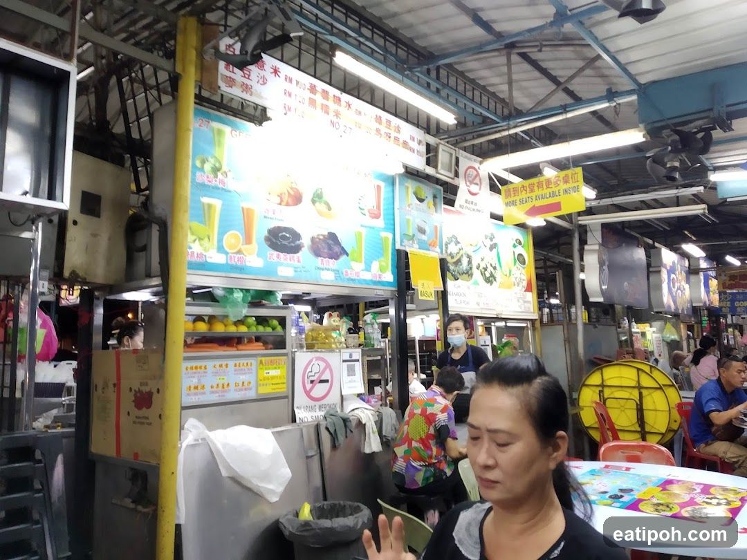 Food stall interior with customers and signage
