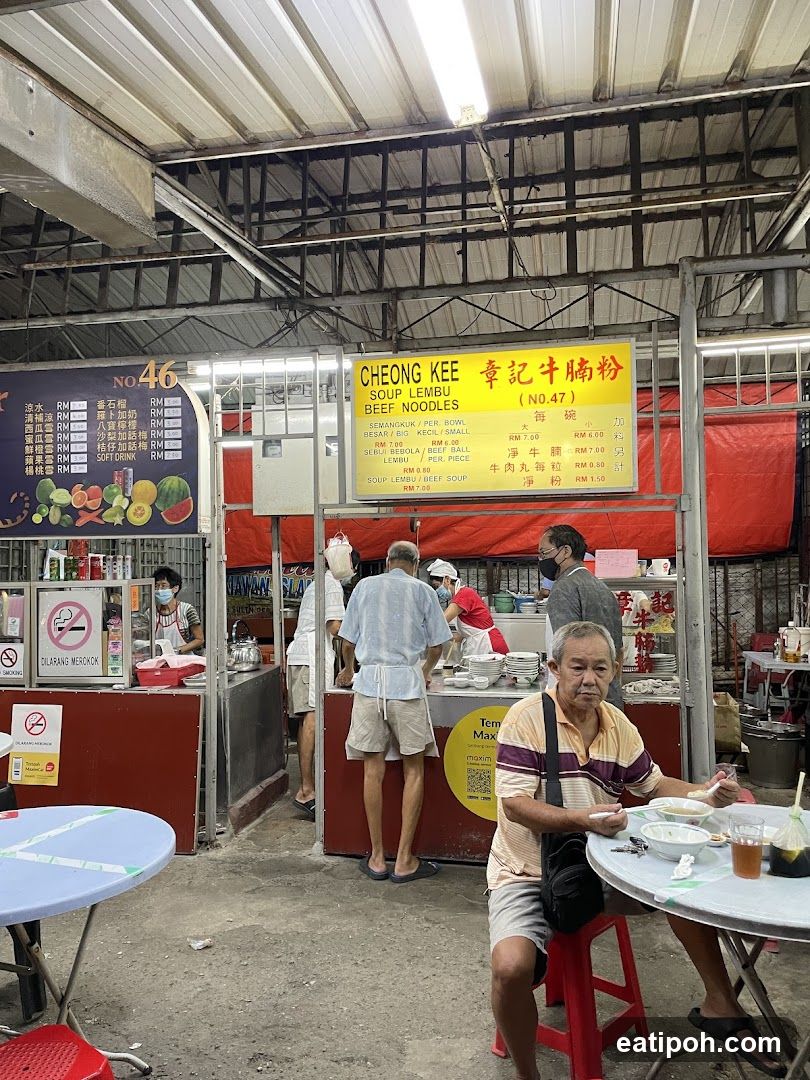Food stall interior with customers and staff