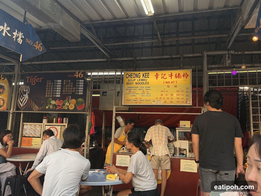 Food stall interior with customers and staff