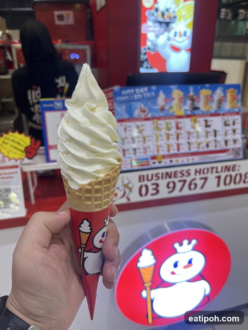 Ice cream cone held in hand at a store counter