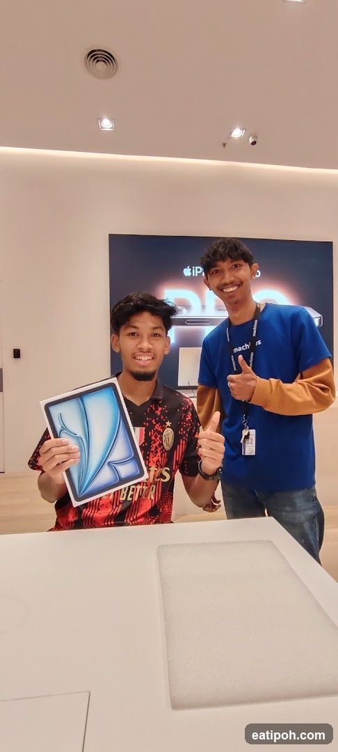 Two individuals in Apple store interior