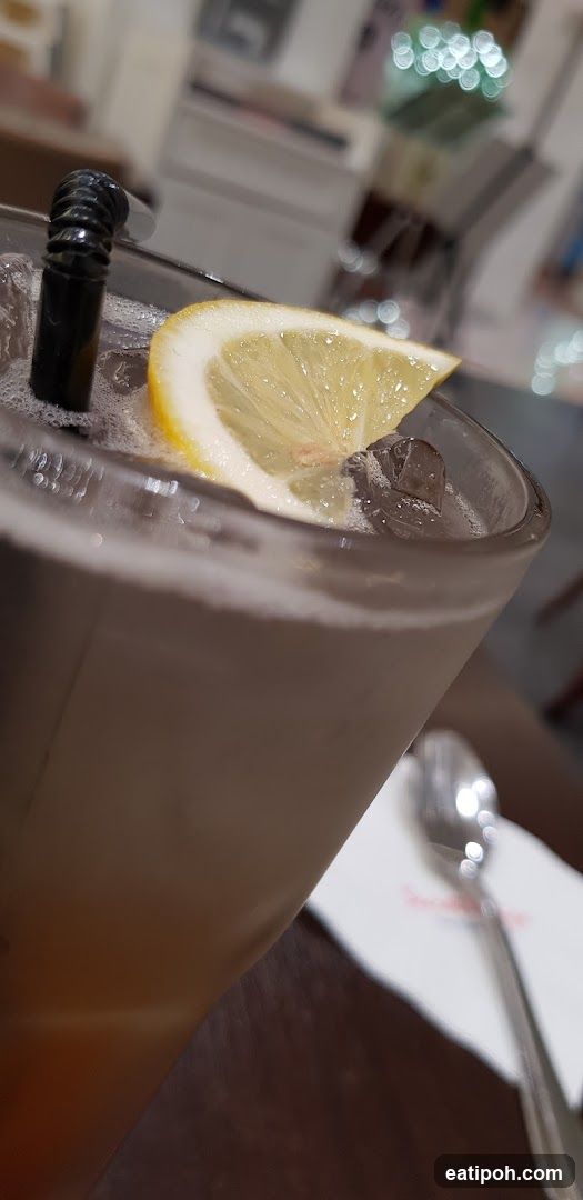 Iced beverage with lemon garnish