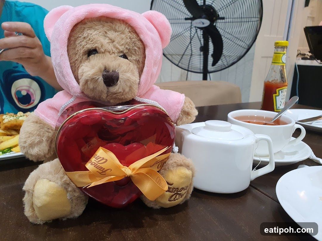Teddy bear with heart-shaped box on table