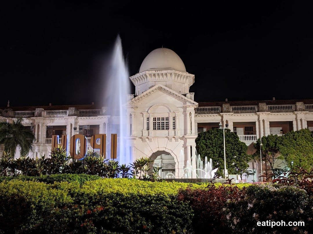 Nighttime View of Historic Building with Fountain