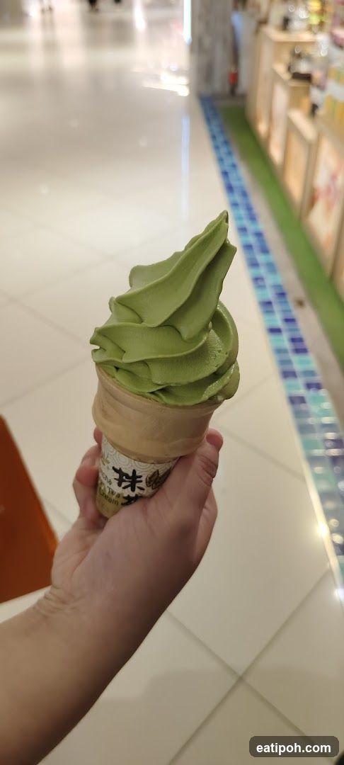 Hand holding matcha ice cream