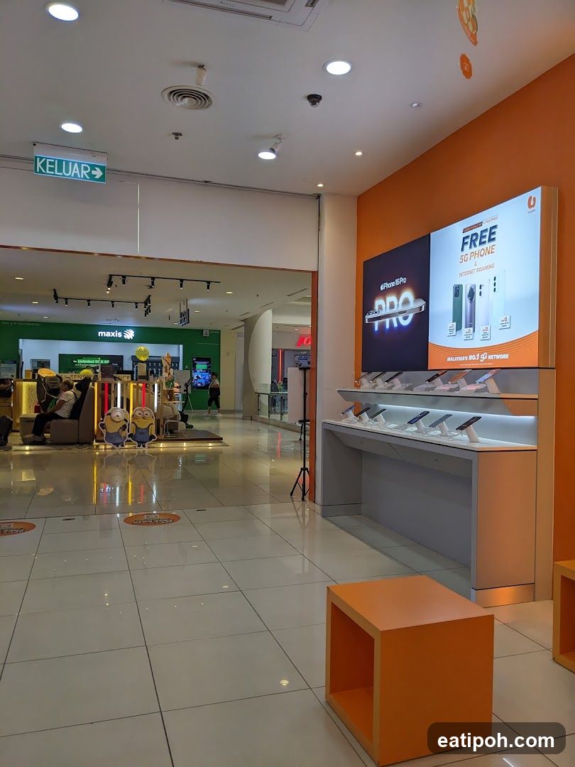 Interior of shopping mall with telecom store display
