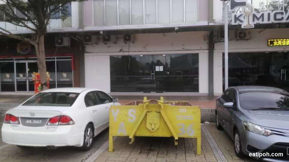 Street scene with parked cars and yellow barrier