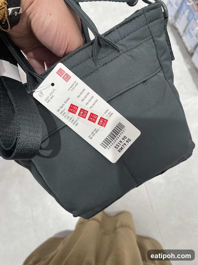 Hand holding Uniqlo bag