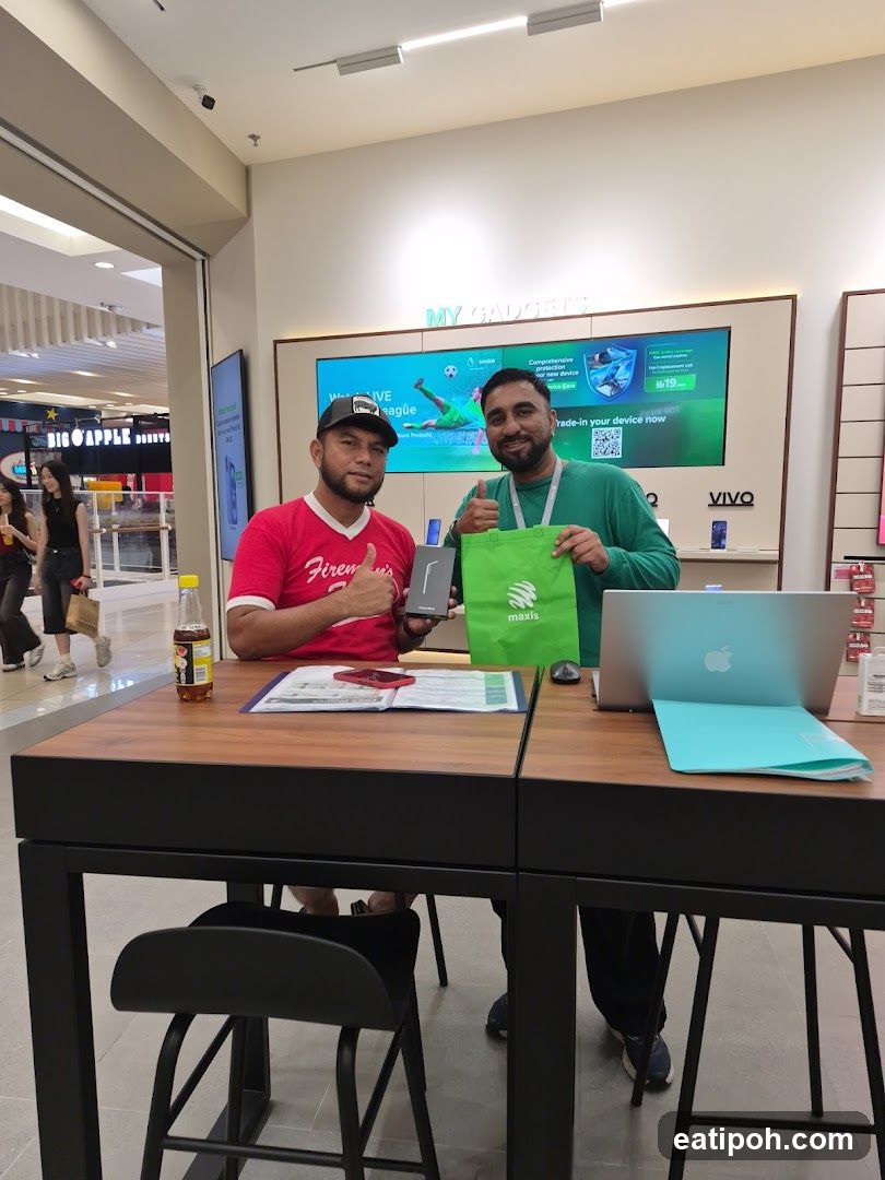 Two individuals at a tech store counter