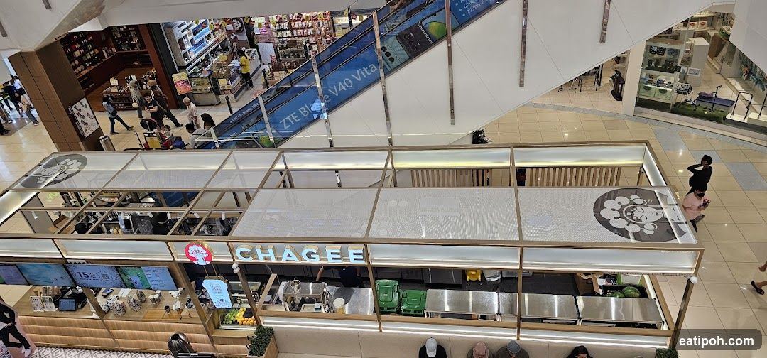 Interior view of shopping mall with food stall and escalator