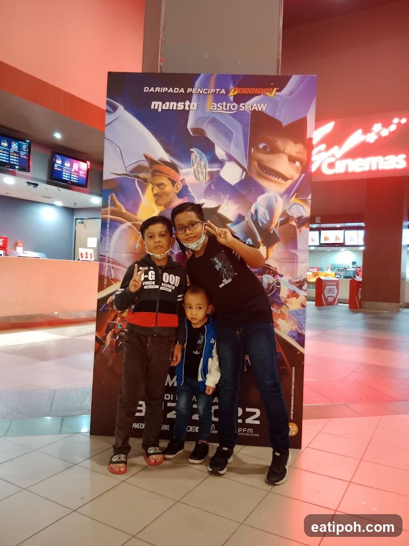 Family posing in cinema lobby