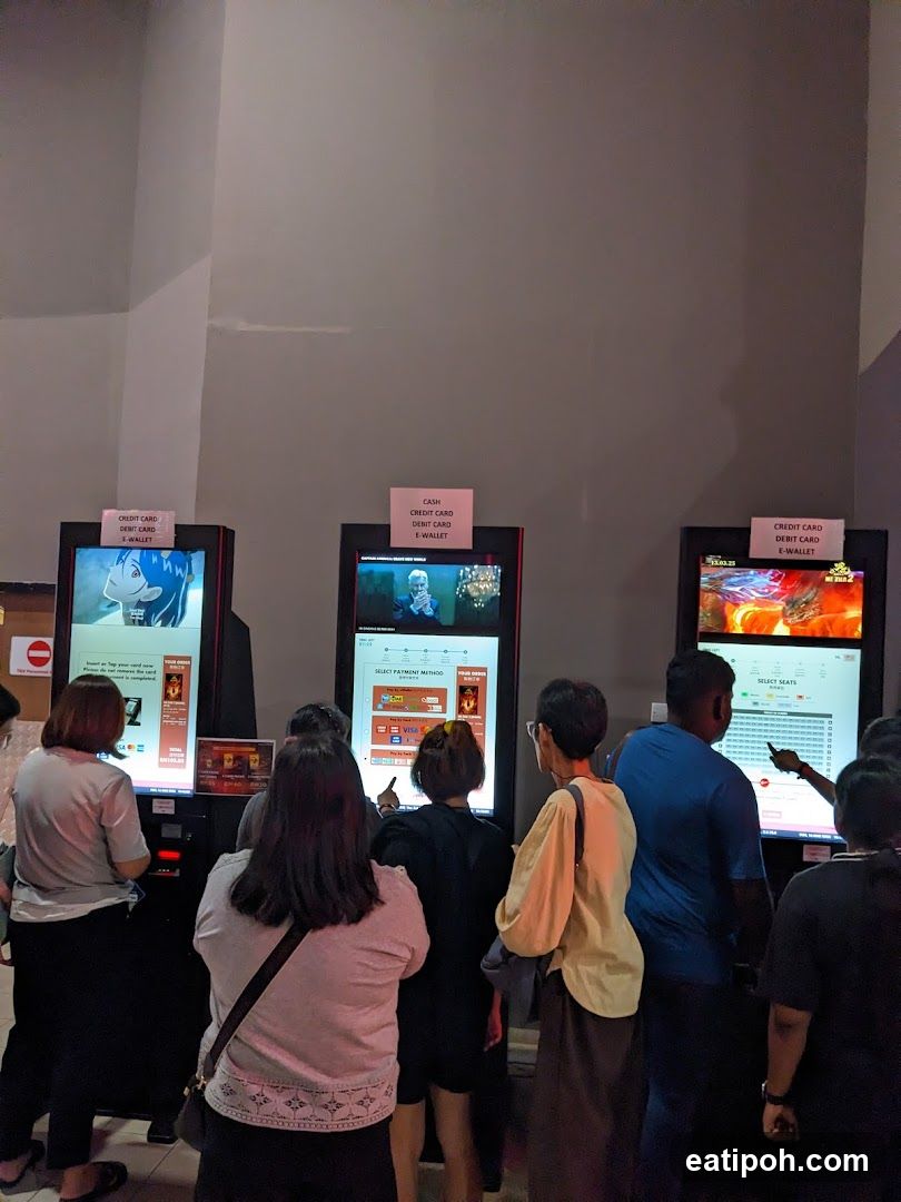 People at ticket kiosks