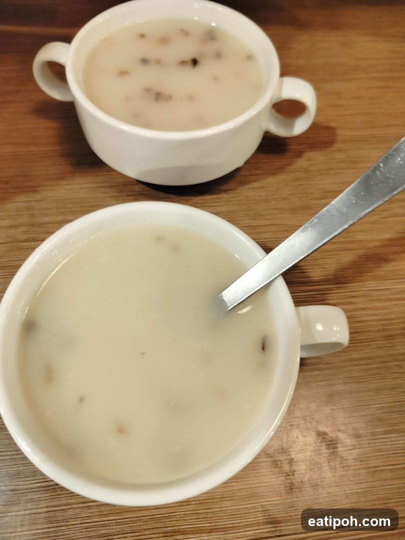 Two bowls of soup on wooden table