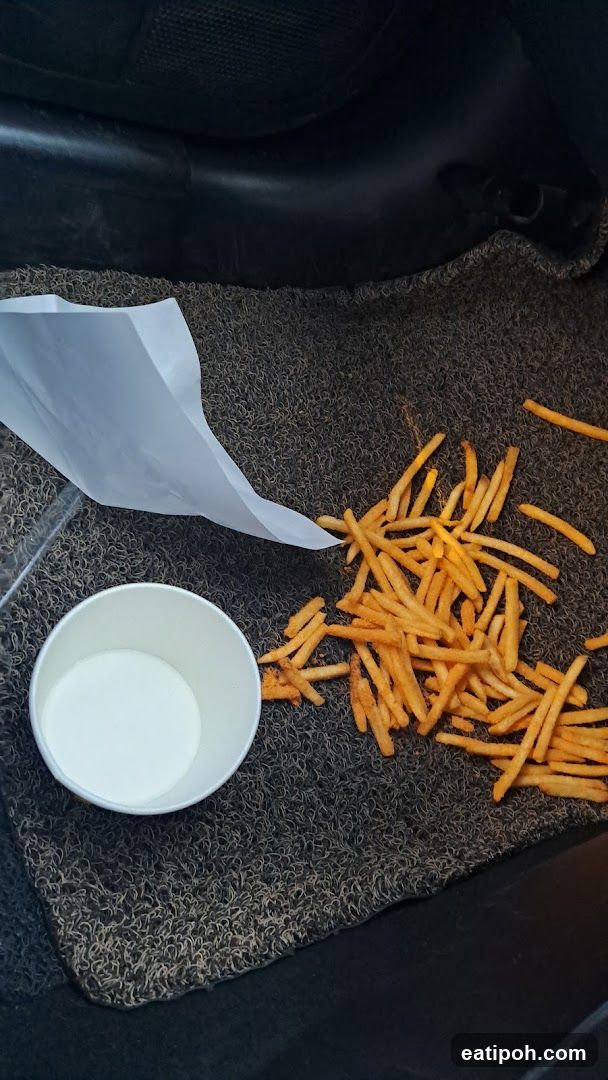 Car Interior with Fries and Cup