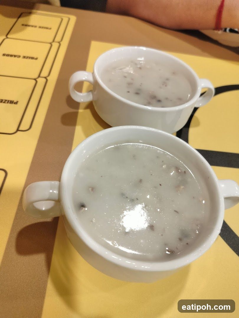 Two bowls of soup on table
