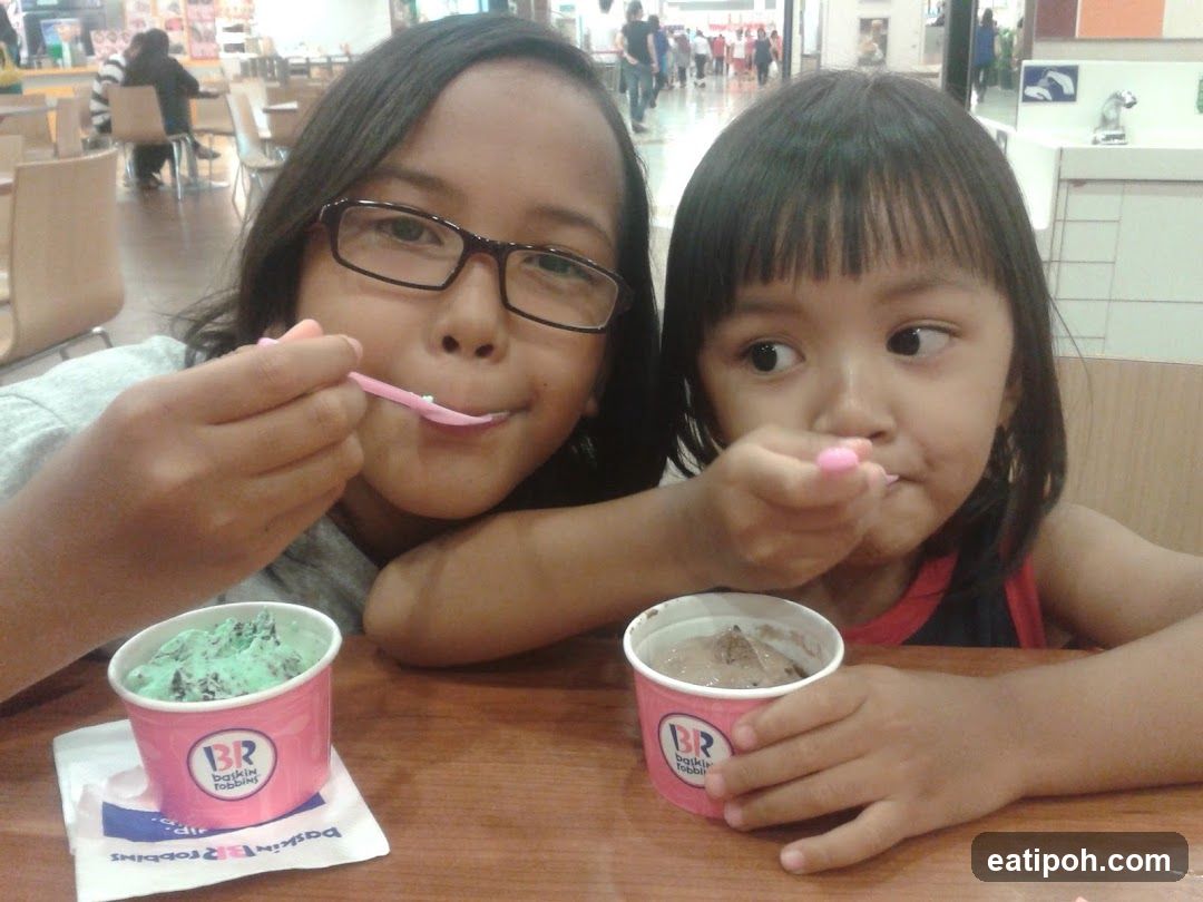Two children eating ice cream at a store
