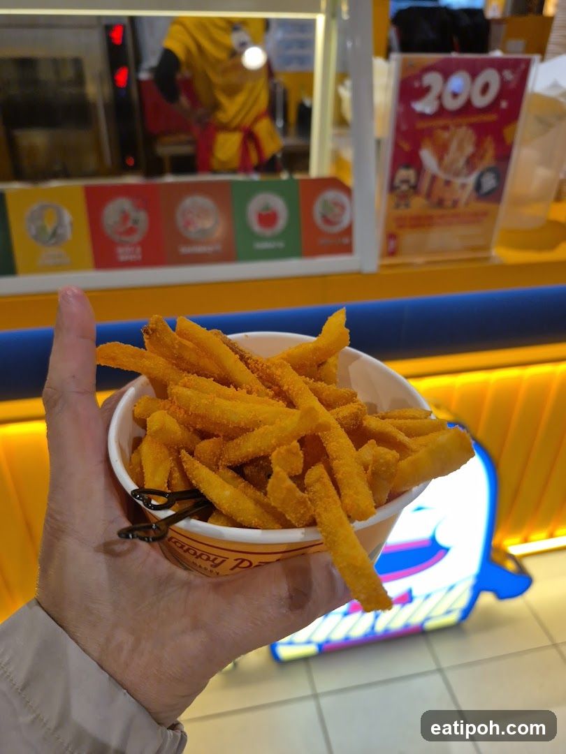 Hand holding fries in food court