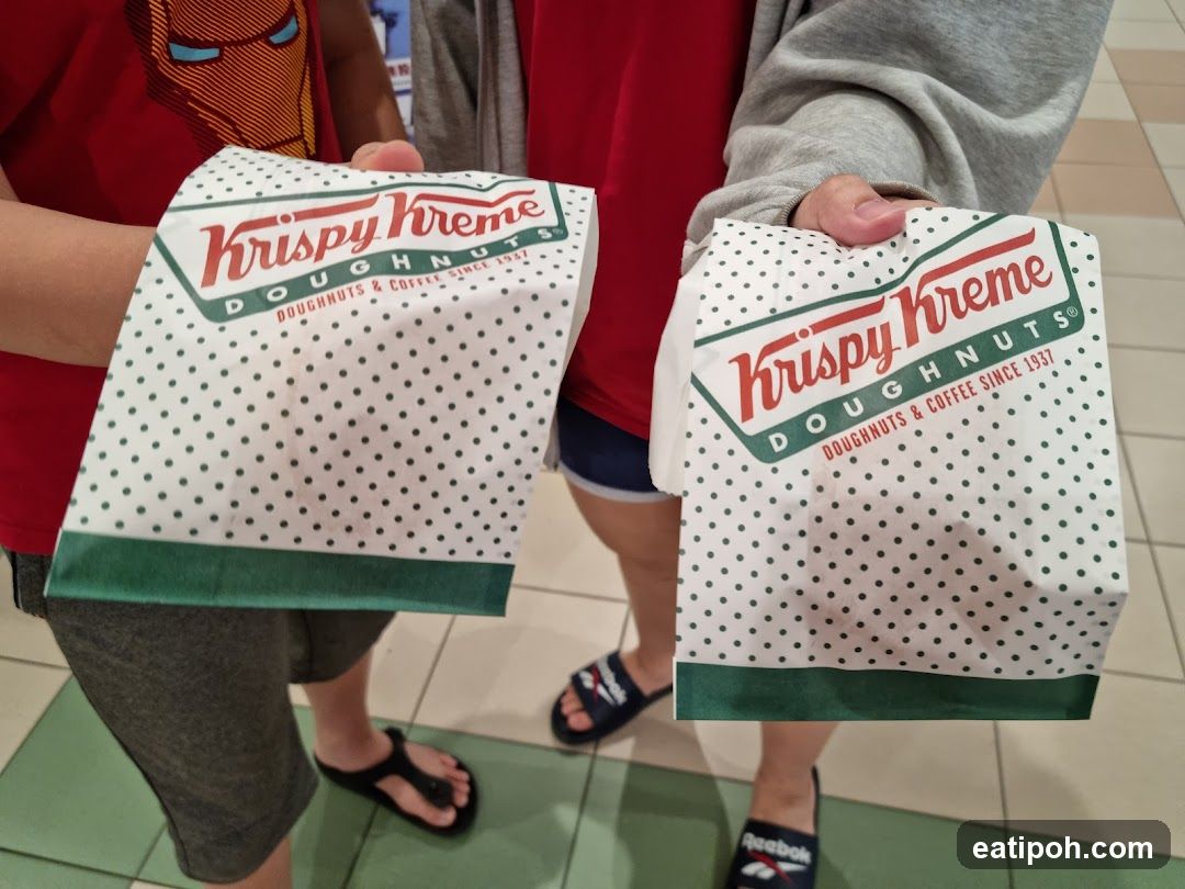 Krispy Kreme Bags Held by Customers