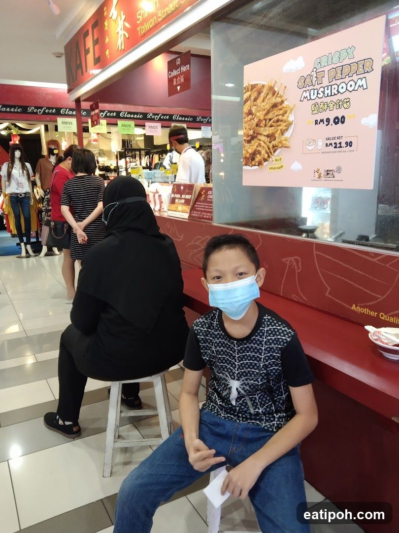 Food stall with promotional poster