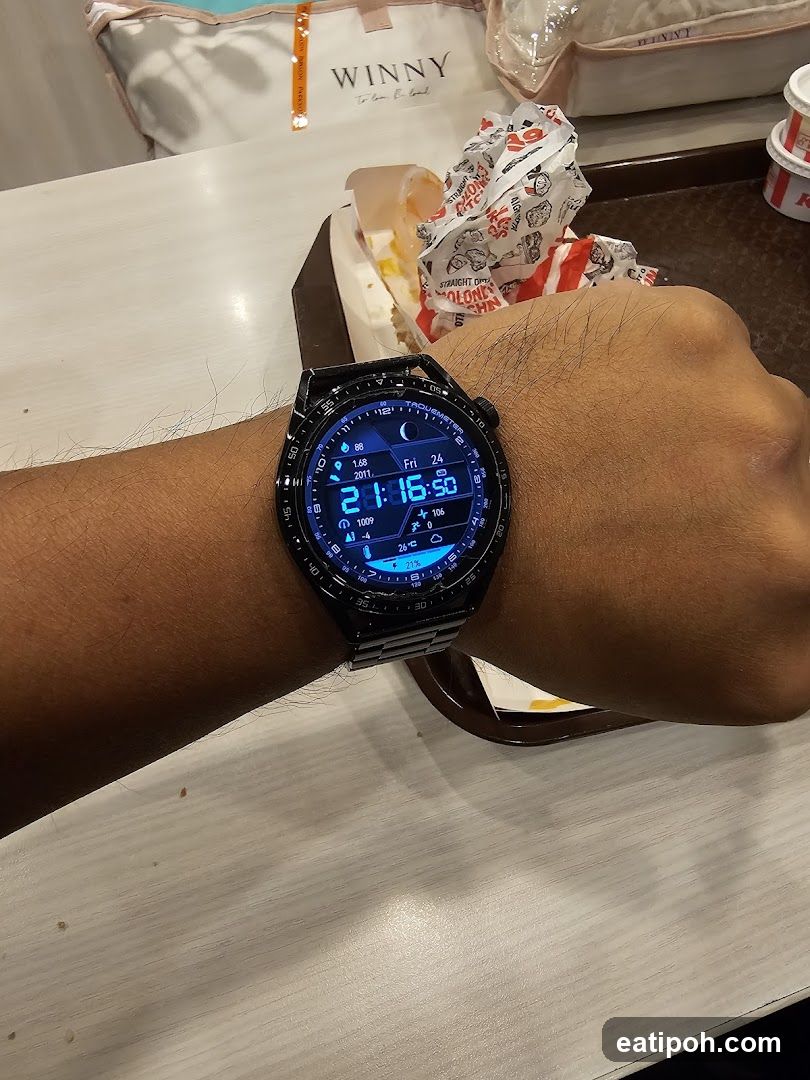 Hand wearing smartwatch at dining table
