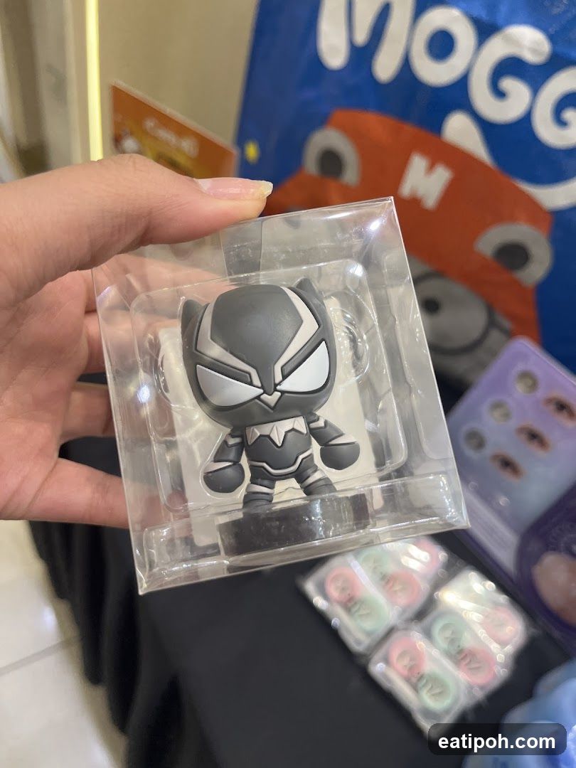 Hand holding figurine in packaging