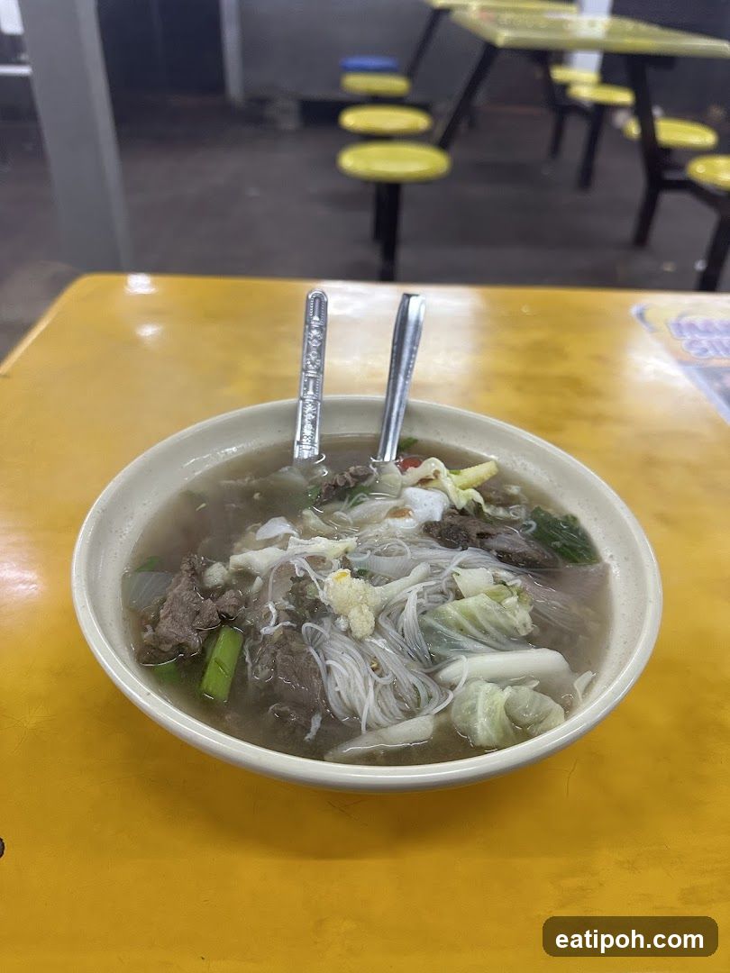 Bowl of noodle soup on yellow table