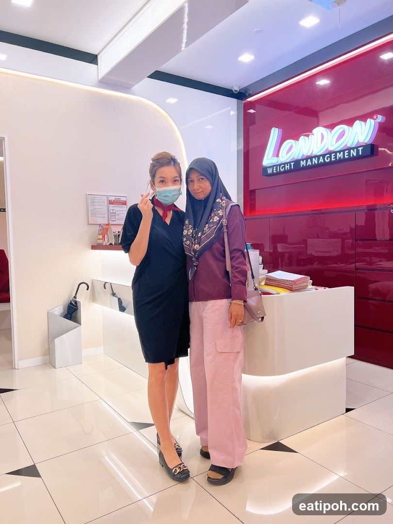 Two individuals posing inside a weight management center