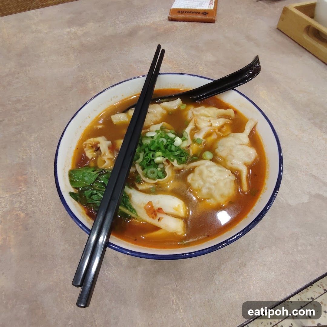 Bowl of soup with chopsticks and spoon