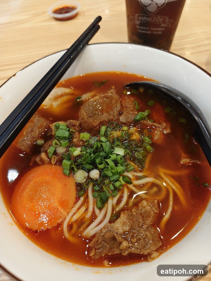 Bowl of noodle soup with chopsticks and drink