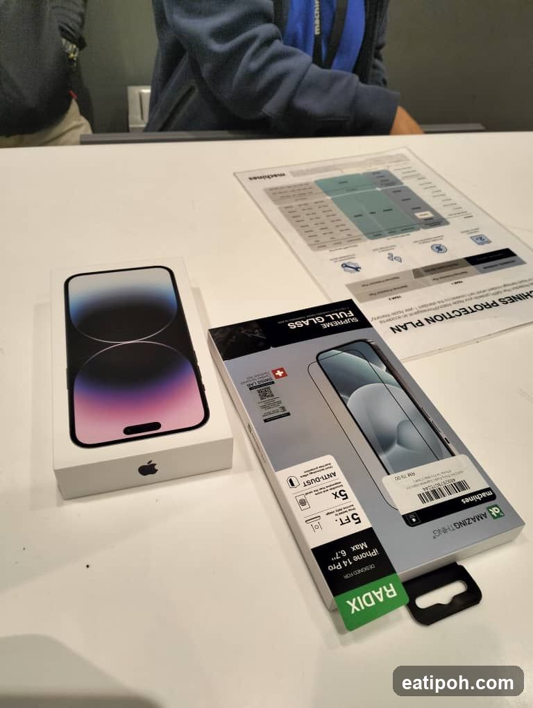 Table with Apple iPhone 14 Pro Box and Screen Protector