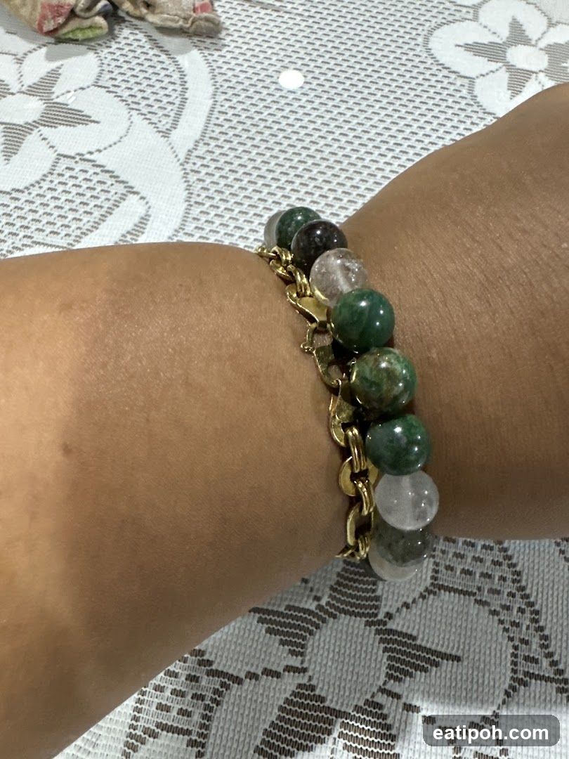 Hand wearing gemstone bracelet