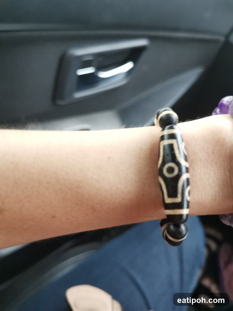 Hand wearing bracelet in car interior