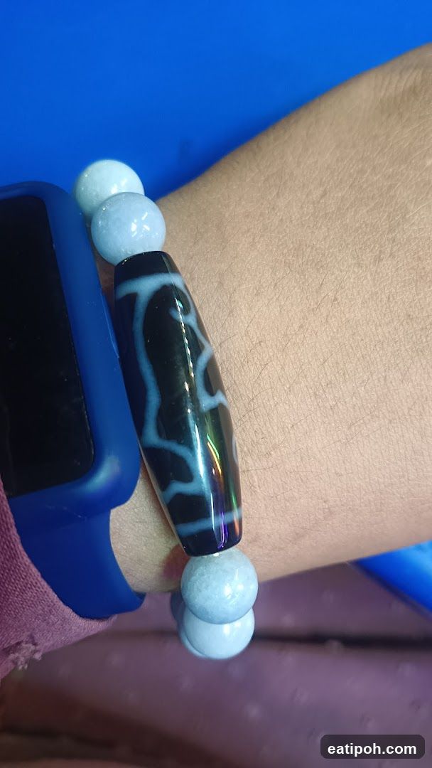 Hand wearing bracelet and smartwatch