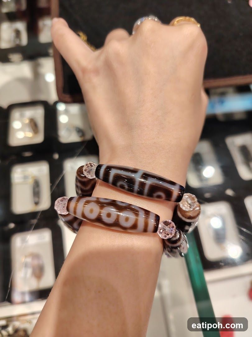 Hand wearing bracelets in jewelry store