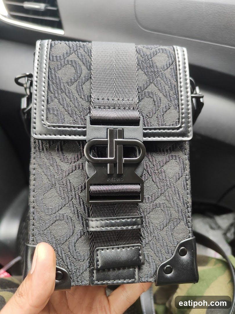 Hand Holding Black Patterned Bag