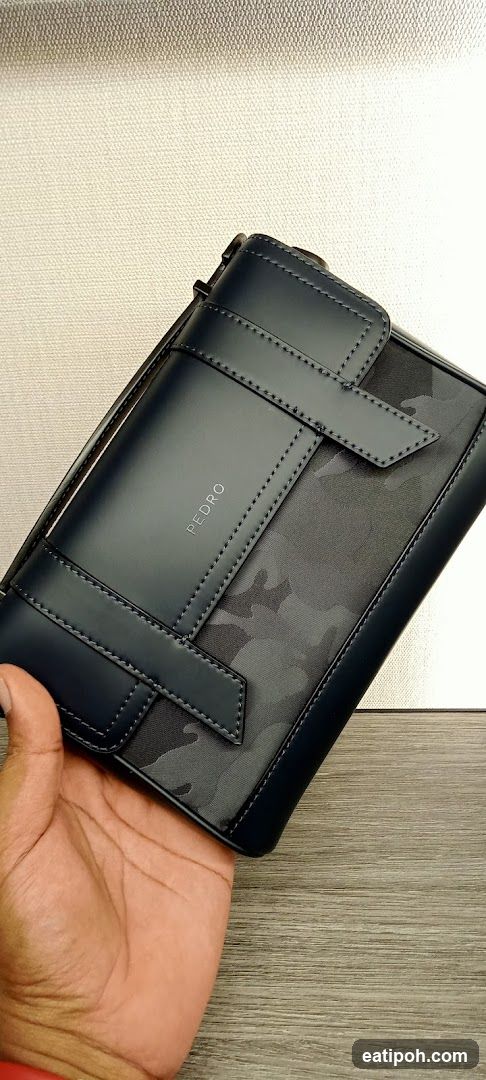 Hand holding a PEDRO wallet