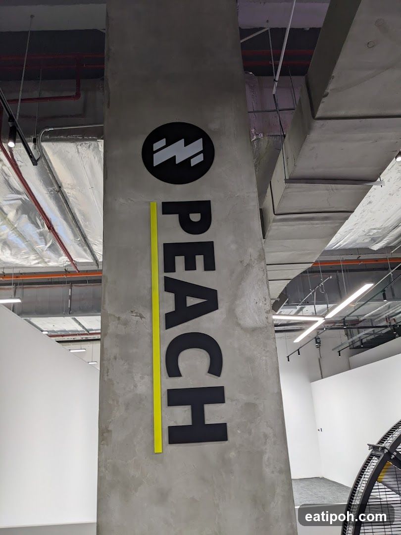 Peach Logo on Concrete Pillar