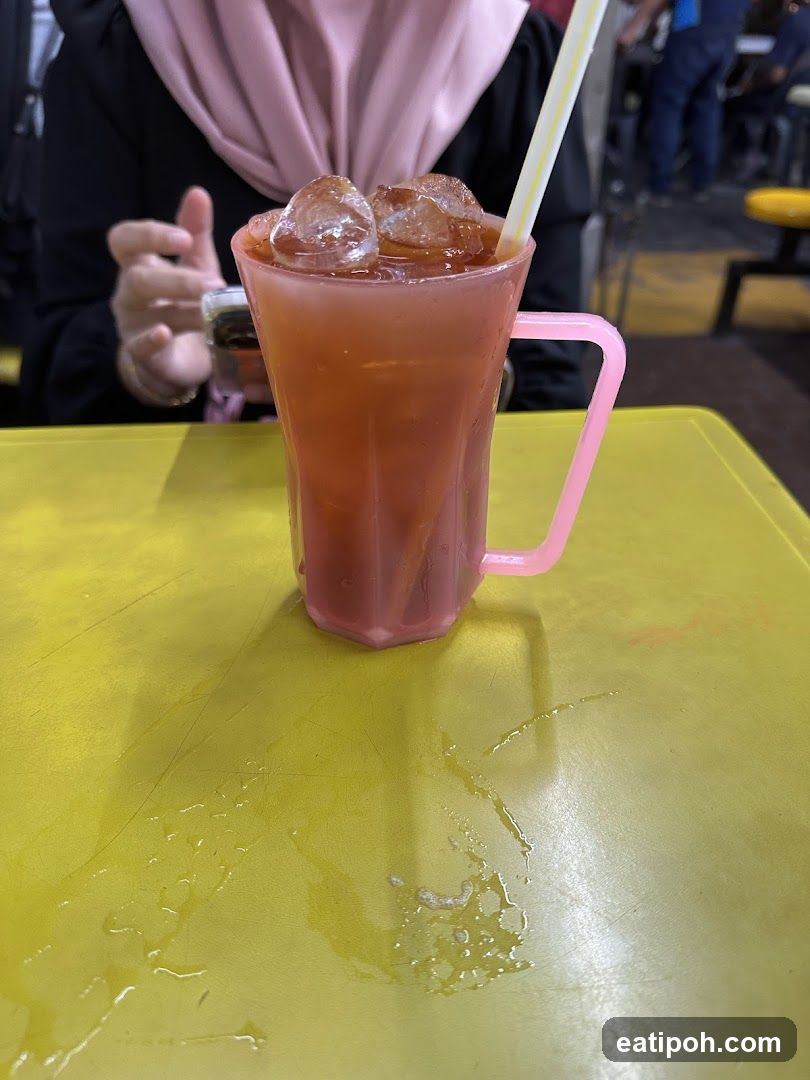 Person with iced drink at table