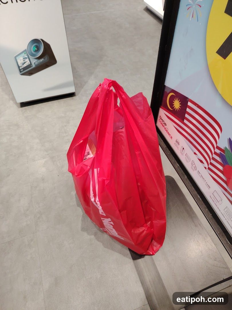 Red shopping bag on floor near promotional display