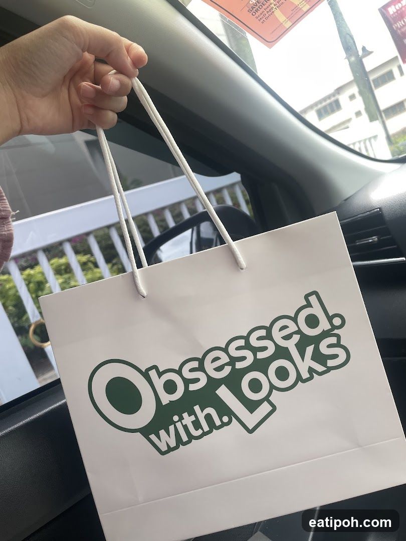 Hand holding shopping bag inside car