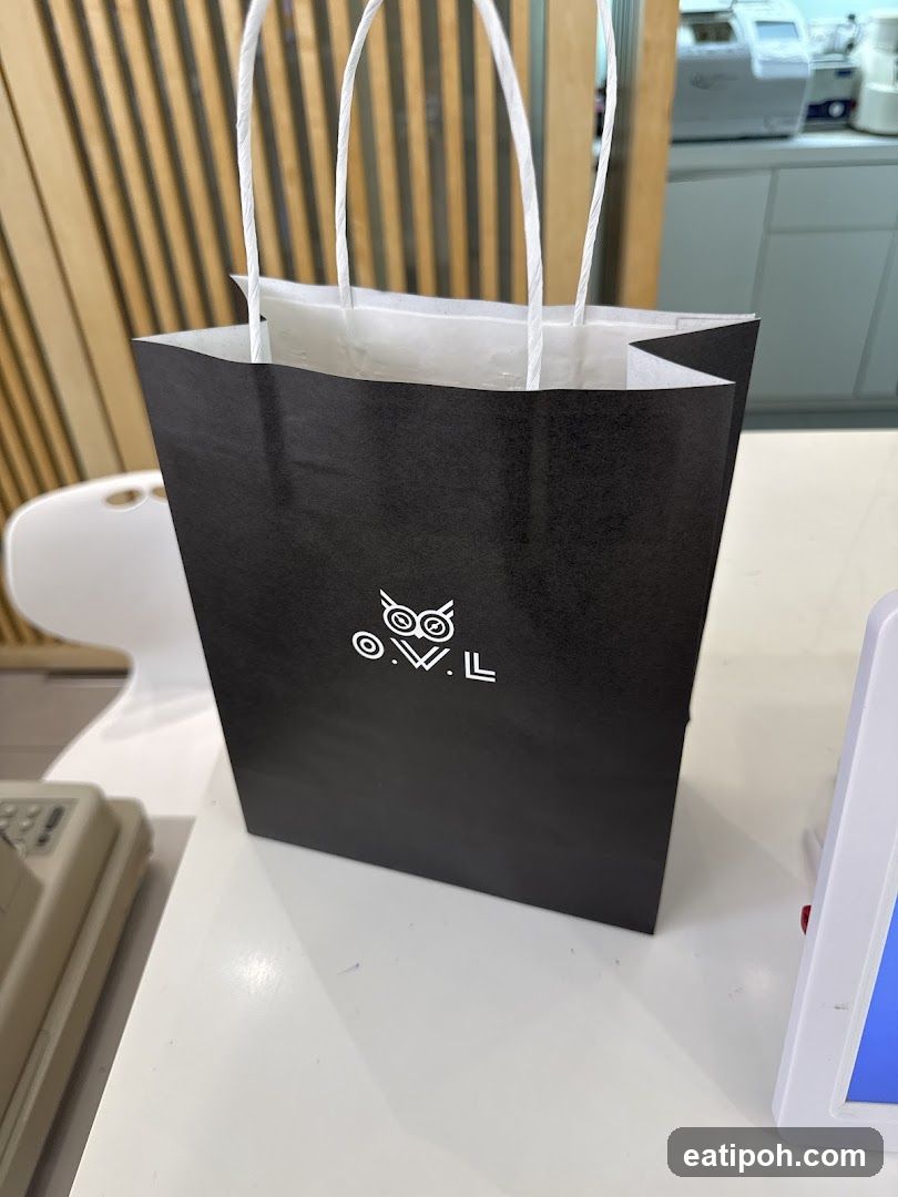 Black paper bag with logo
