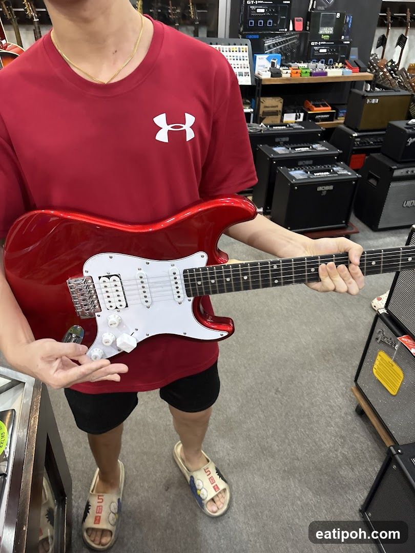 Person holding guitar in music store