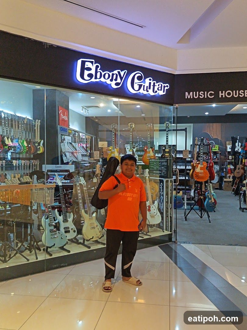 Person in front of Ebony Guitar store